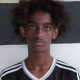 Young male soccer player in black and white uniform posing for a team photo.