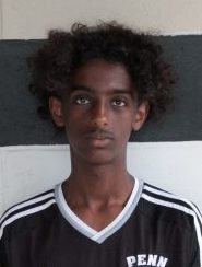 Young male soccer player in black and white uniform posing for a team photo.