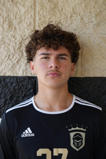 Boys soccer player Evan Wilson posing for a team portrait.