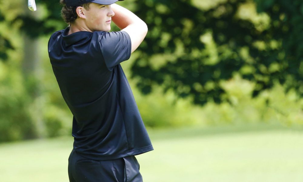 Corbin O'Hara watches his drive on the golf course.