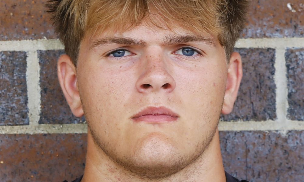 Young man in sports uniform posing for portrait.
