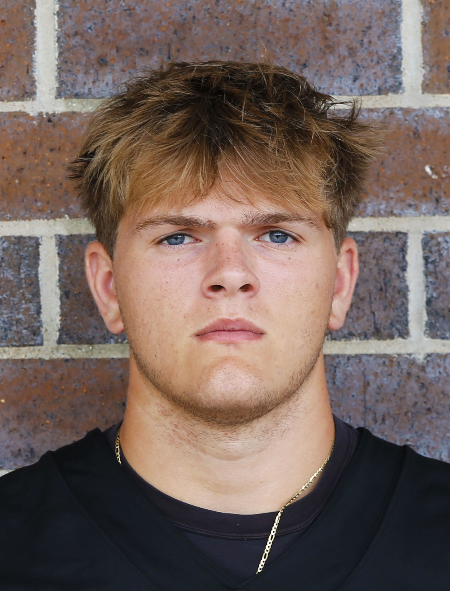 Young man in sports uniform posing for portrait.
