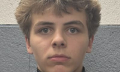 Man in a hockey uniform looking at the camera.