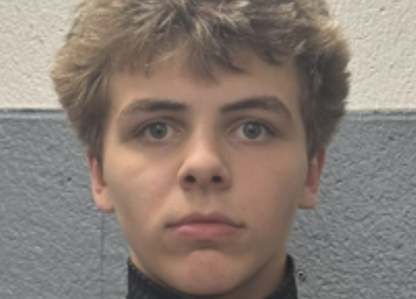 Man in a hockey uniform looking at the camera.