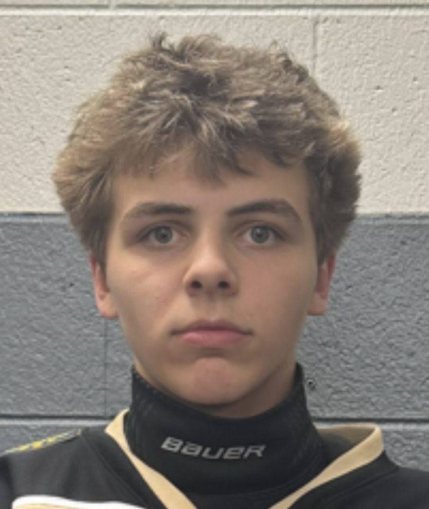 Man in a hockey uniform looking at the camera.