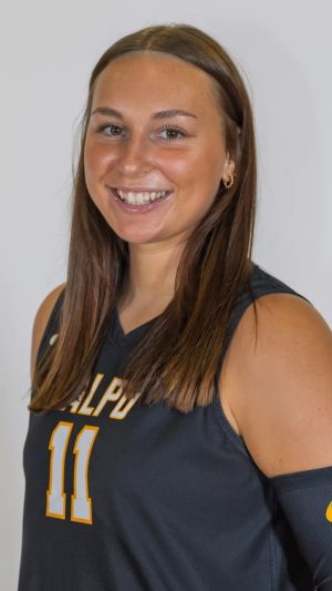 Ally Kois wearing brown volleyball uniform posing for a portrait.