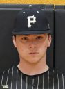 Baseball player wearing a black and white uniform with a baseball cap.