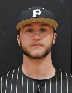 Man in baseball uniform posing for picture.