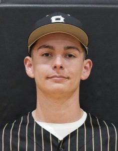This is a portrait of a young male athlete wearing a baseball uniform, posing for a team photo.