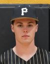 Man wearing a baseball cap with the letter p on it, posing for a portrait in a school uniform.
