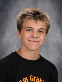 Young man with spiky hair posing for school portrait.