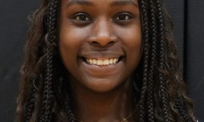 Woman wearing a black shirt smiling at the camera.