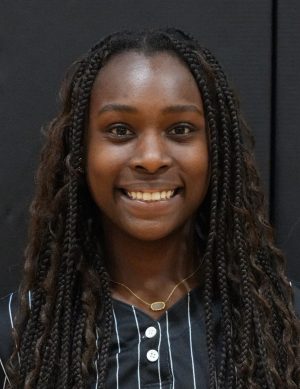Woman wearing a black shirt smiling at the camera.