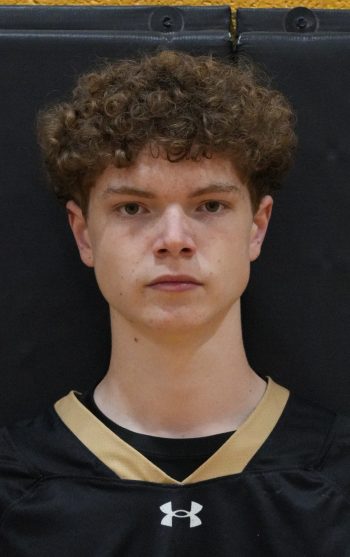 Lacrosse athlete wearing a black uniform with white lettering.