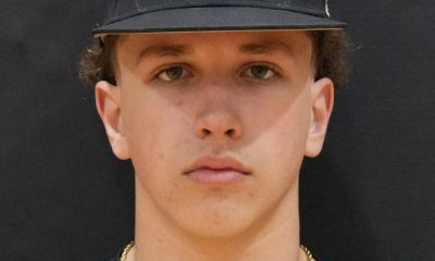 Man in baseball uniform posing for portrait.