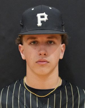 Man in baseball uniform posing for portrait.