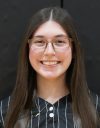 Girl in glasses smiling at camera.