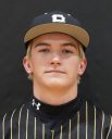 Baseball player posing in uniform for team portrait.