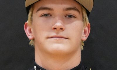 Baseball player posing in uniform for team portrait.