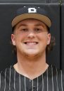 Man in baseball uniform smiling at camera.