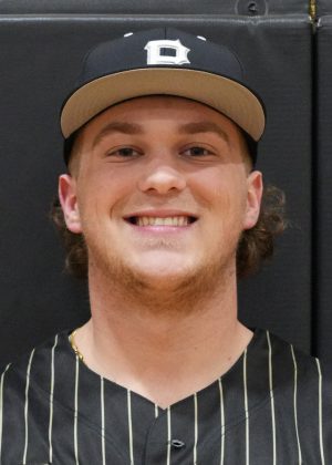 Man in baseball uniform smiling at camera.