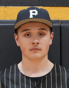 Baseball player in uniform posing for portrait.