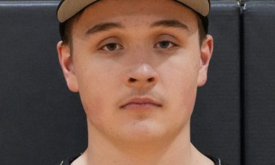 Baseball player in uniform posing for portrait.