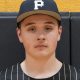 Baseball player in uniform posing for portrait.
