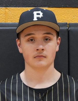 Baseball player in uniform posing for portrait.