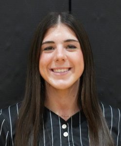 Woman in striped shirt smiling at camera.