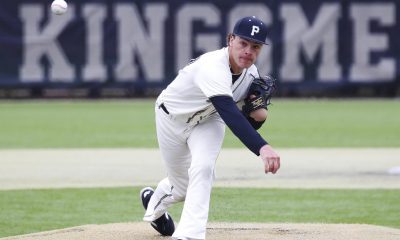 Baseball player in mid-action on field.
