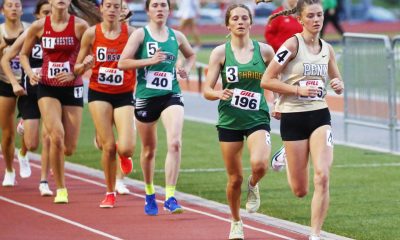 Athletes running in a race on a track.
