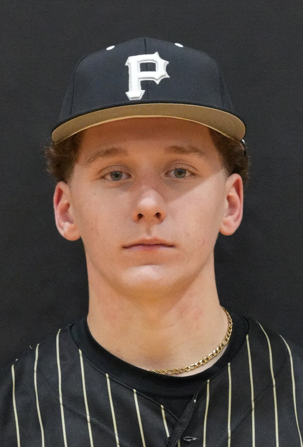 Baseball player wearing a black and white uniform.