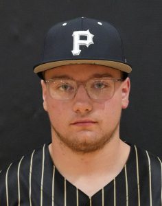 Man wearing glasses, black baseball cap with white lettering, and sports jersey.