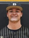 Man in baseball uniform smiling at camera.