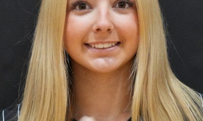 Girl in black and white striped shirt posing for a portrait.