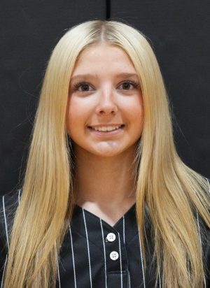 Girl in black and white striped shirt posing for a portrait.