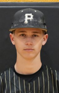 Baseball player in uniform posing for a portrait.