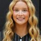 Woman with long blonde hair smiling at camera.