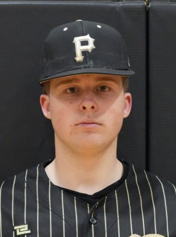 Baseball player in uniform posing for team portrait.