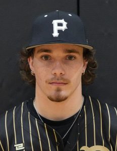Man in baseball uniform holding a baseball bat.
