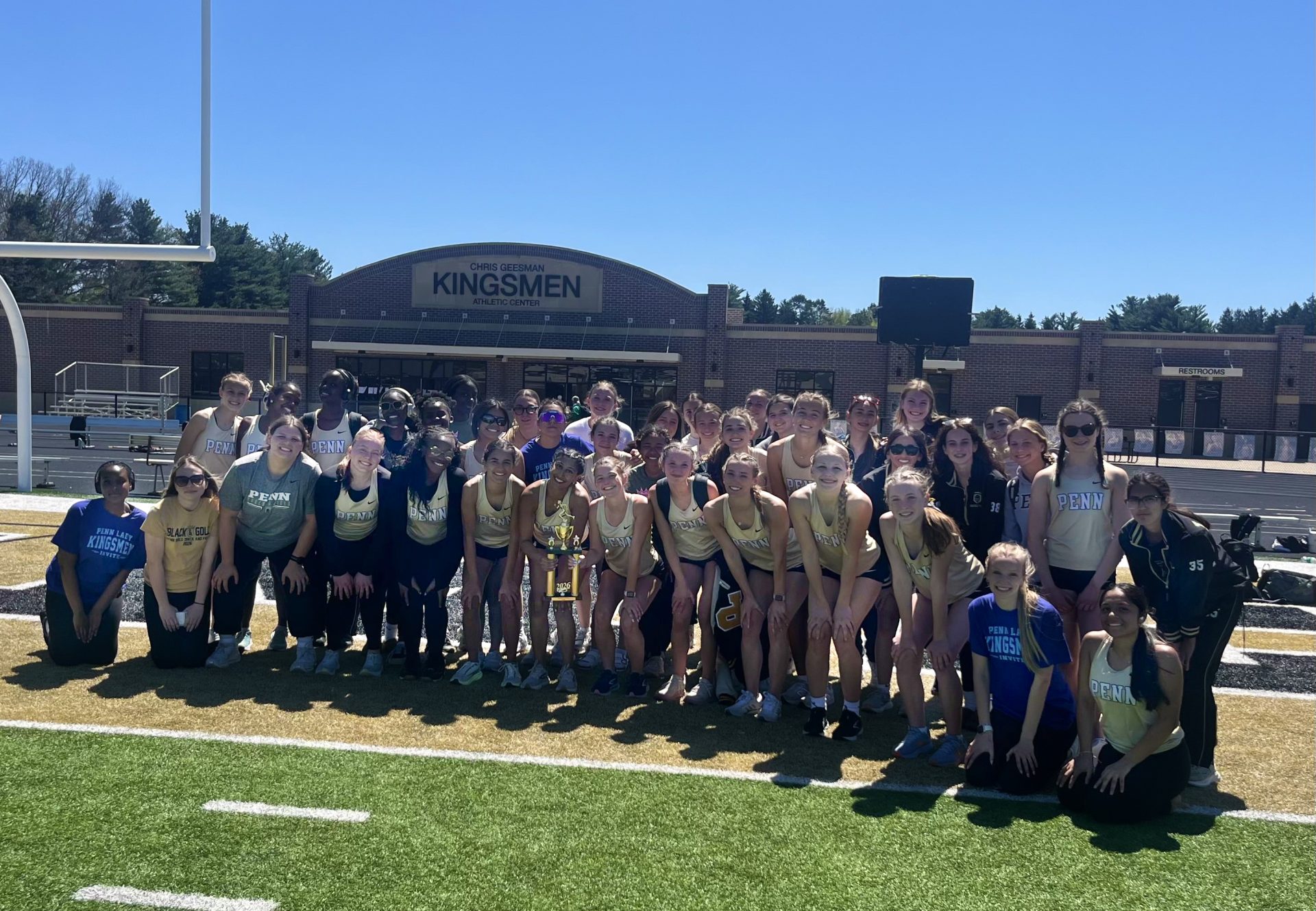 Girls Track Team poses with a trophy.