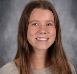Girl in school portrait smiling at camera.