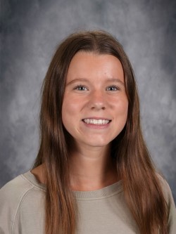 Girl in school portrait smiling at camera.