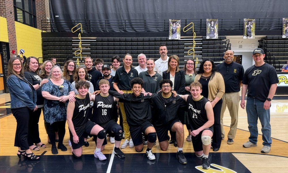 Team of basketball players posing for a picture after a game.