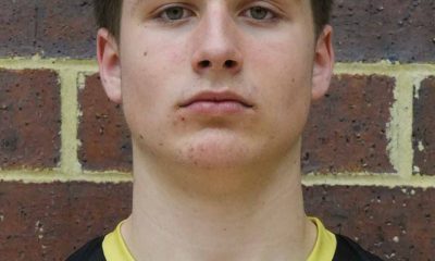 Young male athlete posing for a portrait, looking directly at the camera with a neutral expression.