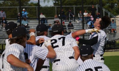 Baseball players celebrating on field.