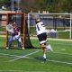 Man playing lacrosse on field.