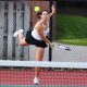 Woman playing tennis on court.