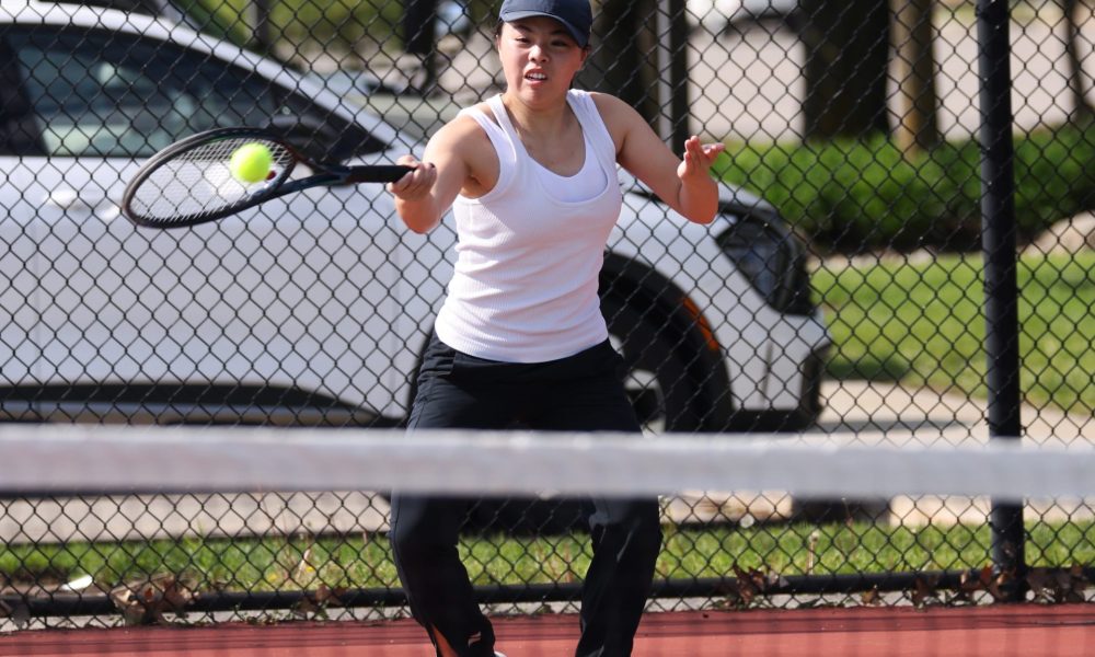 Woman playing tennis on court.